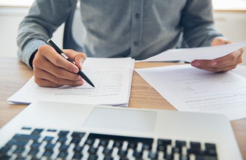 Businessman checking documents at table Businessman checking documents at table